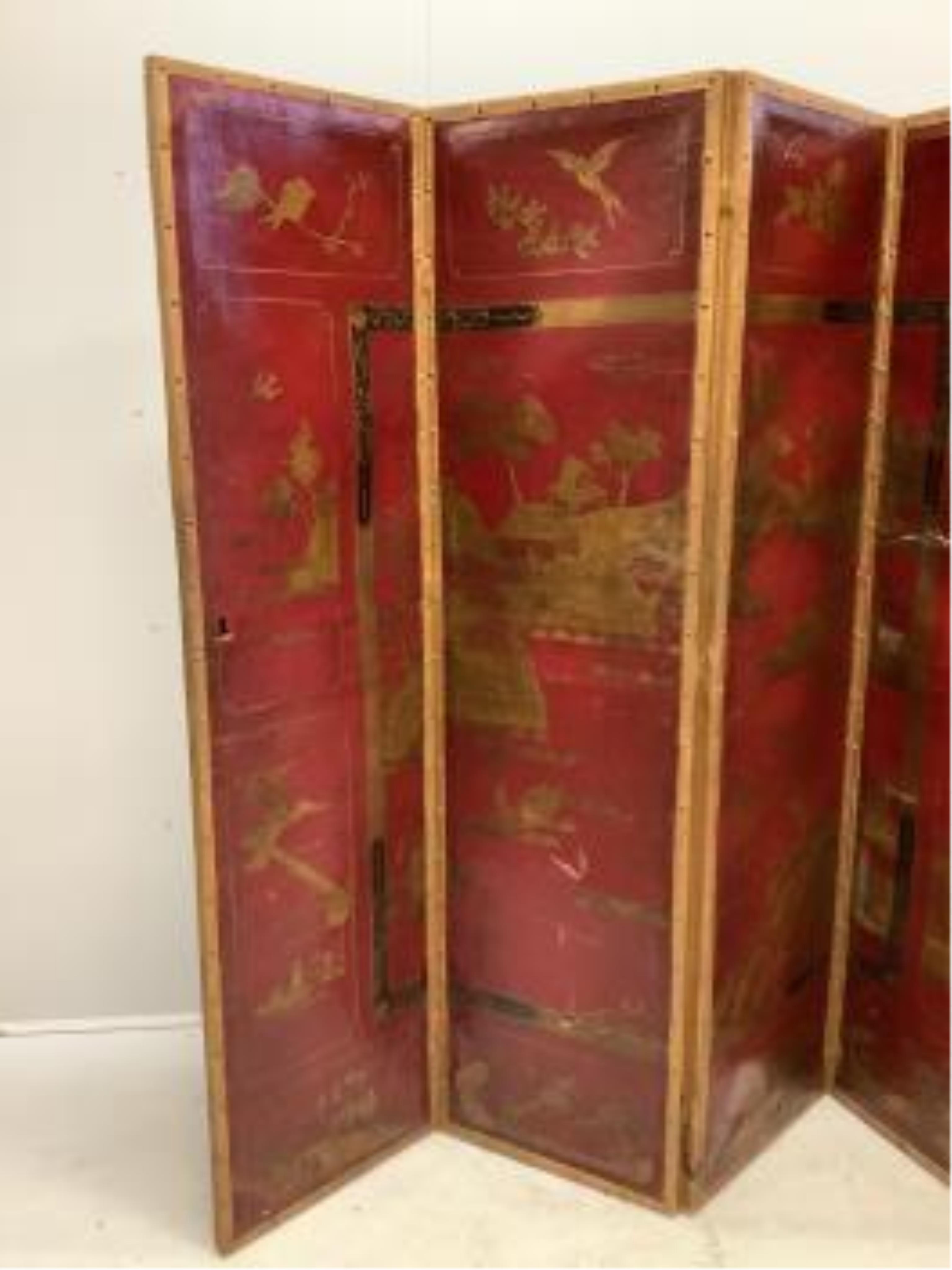 An early 20th century chinoiserie painted leather four fold screen, each panel width 46cm, height 180cm. Condition - poor to fair (two panels holed in three places, one with poor horizontal restoration)